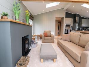 a living room with a couch and a fireplace at 17 The Oaks in Skipton