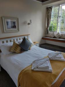 a bedroom with a white bed with towels on it at Red Lion in Exeter