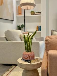 a living room with a table with a plant on it at Gorgeous newly refurbished 2 bedroom apartment in London in London