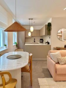 a kitchen and living room with a table and a couch at Gorgeous newly refurbished 2 bedroom apartment in London in London