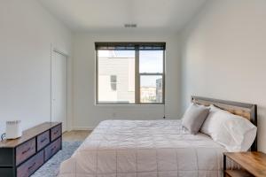 a white bedroom with a large bed and a window at Sleek Philadelphia Retreat with Private Rooftop in Philadelphia