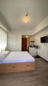 a bedroom with a large bed and a television at Platform 361 in Cebu City