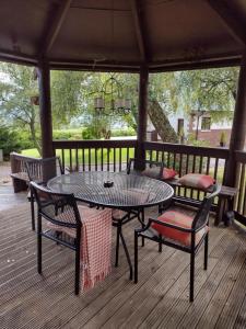 a patio with a table and chairs on a deck at 7 Burnside House in Kilmorack
