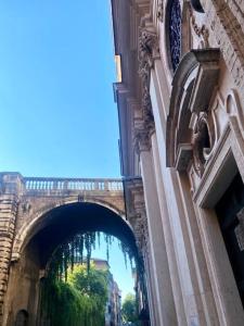 an archway on a building with a bridge in the background at Domus Paolina in Rome