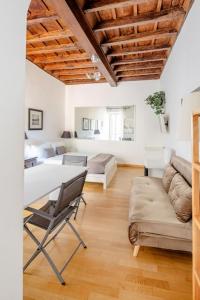 a living room with a table and a couch at Domus Paolina in Rome