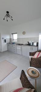 a room with a kitchen and a living room at Silver Oaks Luxury Guest Cottage in Langebaan