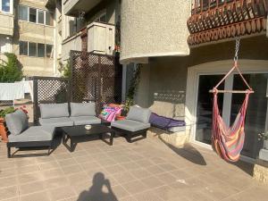 a shadow of a person holding a hammock on a patio at Apartament Olivia in Iaşi