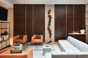 a living room with a couch and two chairs at AC Hotel by Marriott New Orleans French Quarter in New Orleans