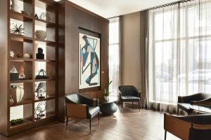 a waiting room with chairs and a table and a window at AC Hotel by Marriott New Orleans French Quarter in New Orleans +53 photos