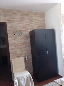 a black cabinet and a chair in a room at Villa Lucia in Lampedusa