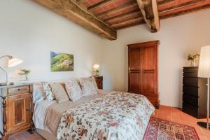 a bedroom with a large bed and a dresser at Casa Lucchese al Borghetto in Collodi +74 photos