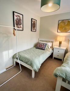 a bedroom with a bed and a lamp in it at Durham City Retreat in Durham
