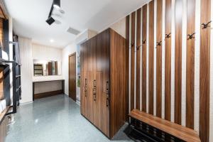 a hallway with wooden lockers in a house at MISTO capsule hotel in Kyiv