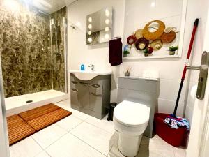 a bathroom with a toilet and a sink and a shower at Executive apartments, nr city centre with private parking in Plymouth +21 photos