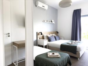 a hotel room with two beds and a window at Solar do Alentejo in Cercal