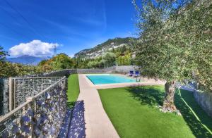 a view of a swimming pool and a fence at Welcome Home Apartment in Lierna