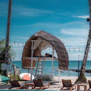 a man sleeping in a bed on the beach at Rest Sea Resort Koh Kood in Ko Kood