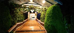 a hallway with a staircase with plants and lights at Sapphire luxury Suites in Ooty