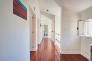 a hallway of an apartment with white walls and wood floors at My Lisbon Home Castelo in Lisbon