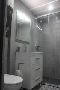 a bathroom with a toilet and a sink and a shower at Apartamento primera línea de mar in Platja  d'Aro