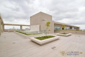 a large building with several plants in front of it at Loft de lujo barranquilla 3Pax in Barranquilla