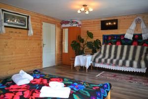 a room with a bed and a table in it at Casa Vladicu in Breb