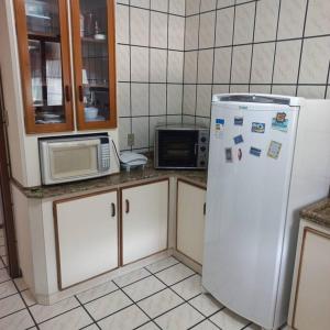 een keuken met een koelkast en een magnetron bij Canto de paz in Brusque