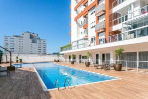 a swimming pool on the side of a building at WI-FI 100mb | Vista Parcial do MAR #CA32 in Florianópolis