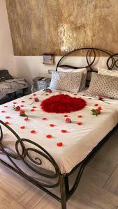 een bed met rode bloemen op een kamer bij Casa Delle Sirene 5 minuti mare Boccadasse in Genua