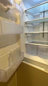 an empty refrigerator with bottles of water in it at Elbon The beach Haeundae in Busan