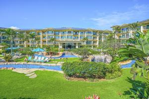 a resort with a swimming pool and a resort at Waipouli Beach Resort H105 in Kapaa