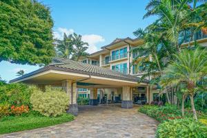 a large building with palm trees in front of it at Waipouli Beach Resort H105 in Kapaa