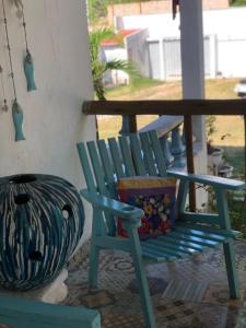 a blue rocking chair sitting on a porch at Pousada Paracuru Surf in Paracuru