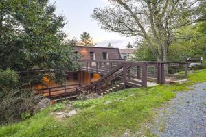 a home with a wooden walkway leading up to a house at Walk to Slopes! Pet-Friendly Beech Mtn Condo in Beech Mountain
