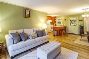 a living room with a couch and a kitchen at Walk to Slopes! Pet-Friendly Beech Mtn Condo in Beech Mountain