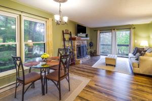 a living room with a table and chairs and a fireplace at Walk to Slopes! Pet-Friendly Beech Mtn Condo in Beech Mountain +18 photos
