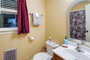 a bathroom with a toilet and a sink and a mirror at Walk to Slopes! Pet-Friendly Beech Mtn Condo in Beech Mountain