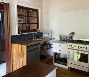 a kitchen with a sink and a stove at Stok&Hoed in Natureʼs Valley