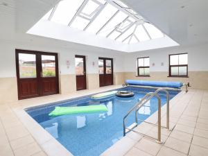 a large swimming pool with a large skylight at Ty Newydd in Dolanog