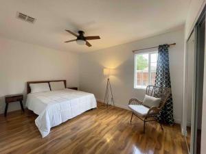 a bedroom with a bed and a ceiling fan at Charming 4 Bedroom Home W/ Large, Gated Backyard in Los Angeles