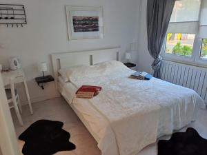 a bedroom with a white bed and a window at Soba Dvori in Zaprešić +1 photo