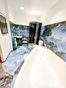 a bathroom with a bath tub and a sink at Bierini Park Studio in Riga