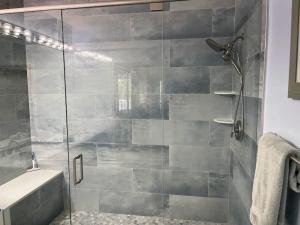 a bathroom with a glass shower with a sink at Right Direction Rentals in Port Saint Lucie