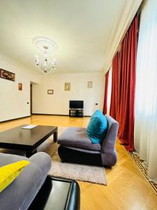 a living room with a couch and a table at Superb Central Location! Spacious and Comfortable 1 Bedroom + Jacuzzi, Next To Northern Avenue in Yerevan