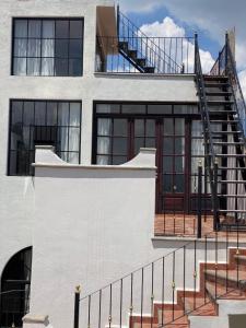 a building with a spiral staircase on the side of it at Casa Laberinto in San Miguel de Allende