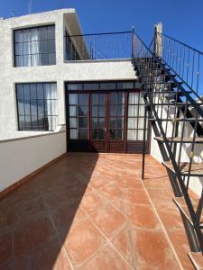 uma casa com uma escada em frente a um edifício em Casa Laberinto em San Miguel de Allende