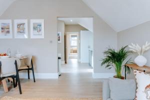 a dining room and living room with a table at Spring Grove Apartment - Central Harrogate in Harrogate