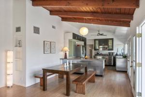 a kitchen with a wooden table and a dining room at Hillside Canyon, Private Home W/ Pool and Nature in Los Angeles