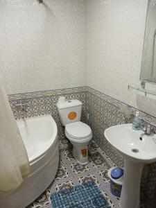 a bathroom with a toilet and a sink at Khiva Bibimariyam in Khiva