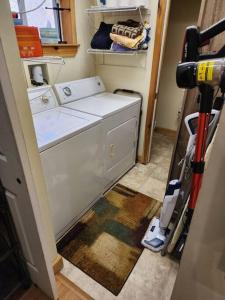 a washer and dryer in a laundry room with at 2 bed, 1.5 bath cottage across from Watauga Lake in Butler
